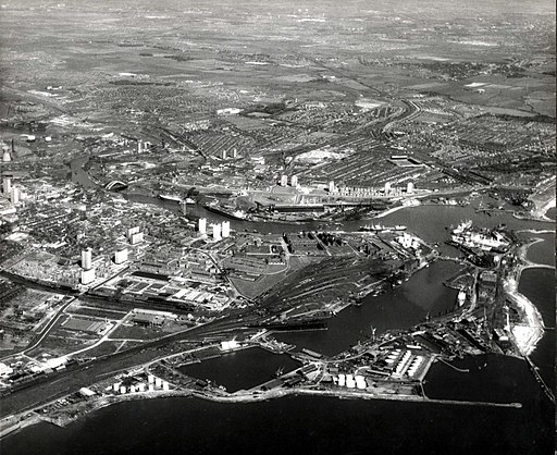 Aerial view of Sunderland South Docks in June 1969, showing the extensive dockyard area, surrounding city, and the nearby river flowing into the sea.