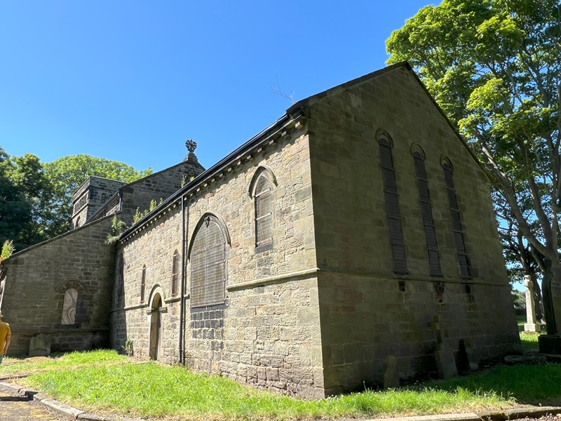 St Mary the Virgin Church stone building in a green setting with blue sky