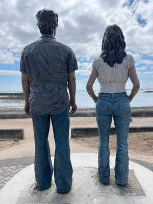 small-scale replica of the "Couple" statue from behind,