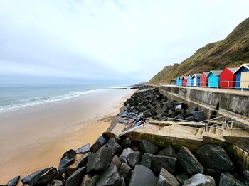 Colourful beach huts on Sheringham Beach, Norfolk UK