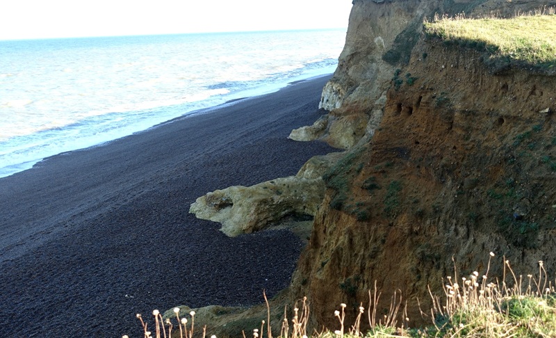 Eroding cliffs along the Norfolk coast showing sediment layers shaped by ancient glacial processes similar to those that formed Doggerland.